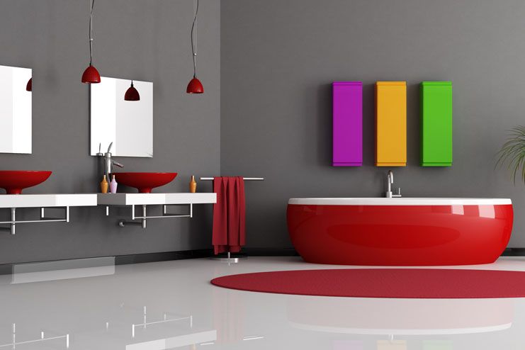 Todas las paredes de este baño se han pintado con esmalte al agua mate 100/ lavable en un tono gris intenso que potencia el rojo del mobiliario.